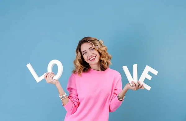 Young woman with word LOVE — Stock Photo, Image