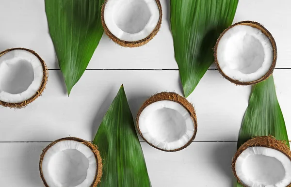 coconut halves and green leaves