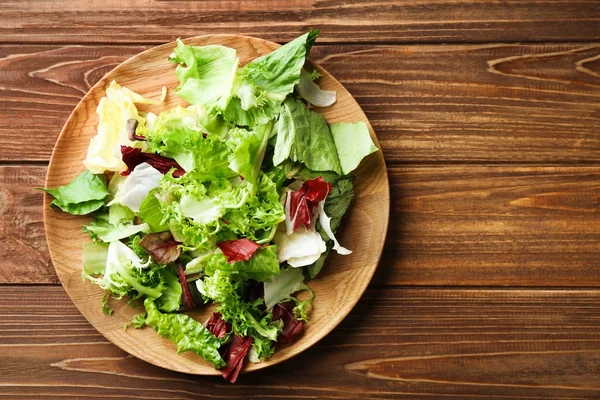 Plate with fresh salad on table — Stock Photo, Image