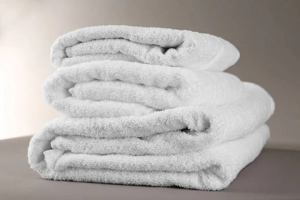 Stack of soft terry towels on grey background — Stock Photo, Image