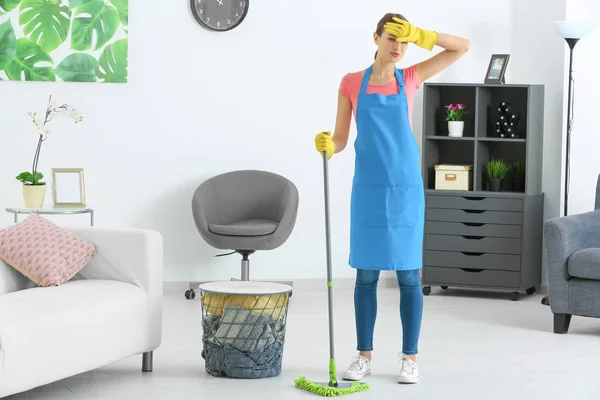 Tired young woman after cleaning flat — Stock Photo, Image