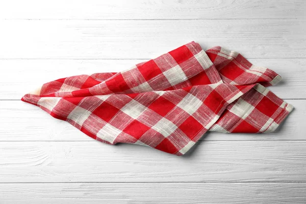 Checkered kitchen towel on white wooden background — Stock Photo, Image