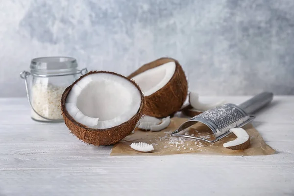 Fresh and desiccated coconut on white table — Stock Photo, Image