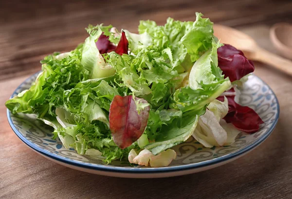 Plate with fresh salad on table — Stock Photo, Image