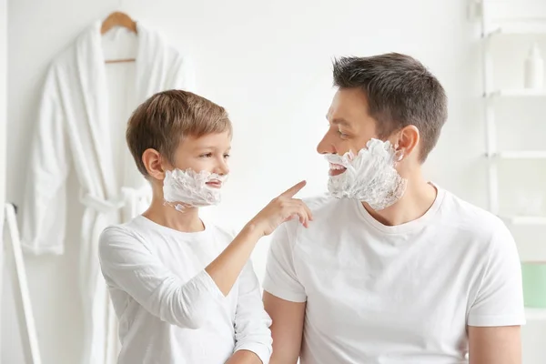 Father and son shaving together in bathroom — Stock Photo, Image