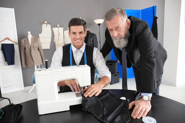 Kleermaker bezig met naaimachine in atelier — Stockfoto