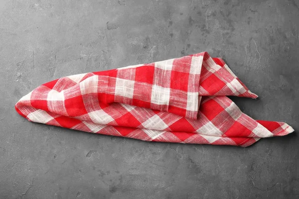 Checkered kitchen towel on grey background — Stock Photo, Image