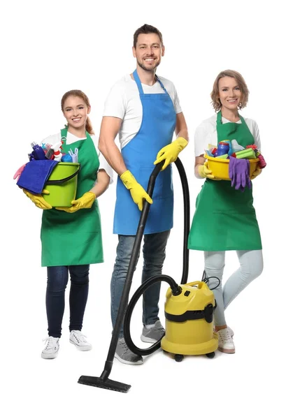 Team of young professionals with vacuum cleaner and supplies, isolated on white — Stock Photo, Image