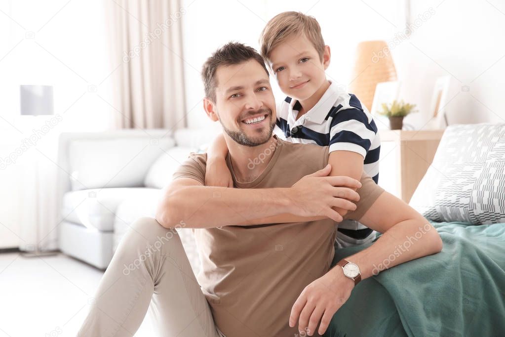 Cute little boy and father at home