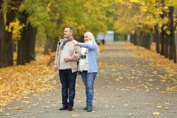 Happy mature couple taking walk in park — Stock Photo, Image
