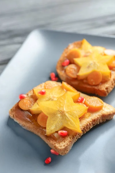 Tasty toasts with jam and fruits — Stock Photo, Image
