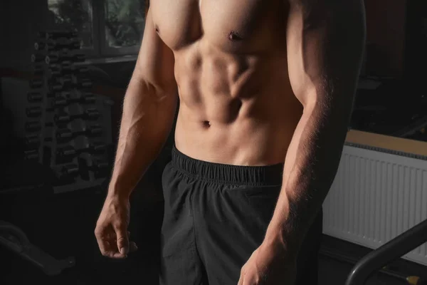 Young strong man in gym — Stock Photo, Image