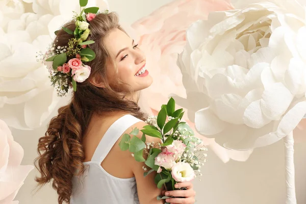 Beautiful young woman with bouquet — Stock Photo, Image