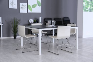 Modern ofis iç tablo ve beyaz sandalye ile