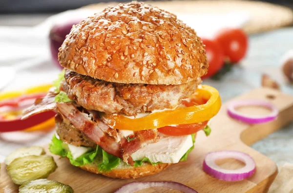 Tasty double burger on wooden board, closeup — Stock Photo, Image