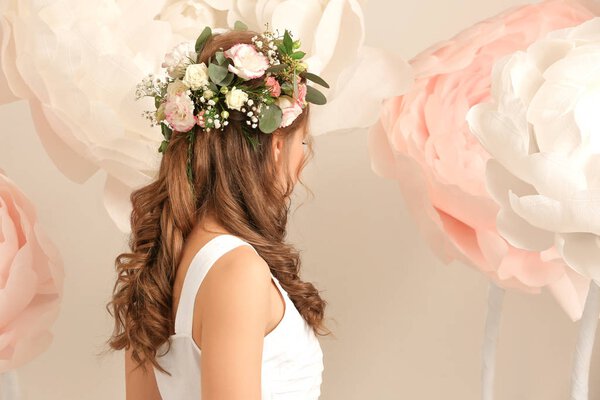 Beautiful young woman with wreath  