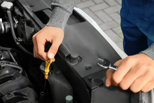Auto mechanic checking oil level, closeup — Stock Photo, Image
