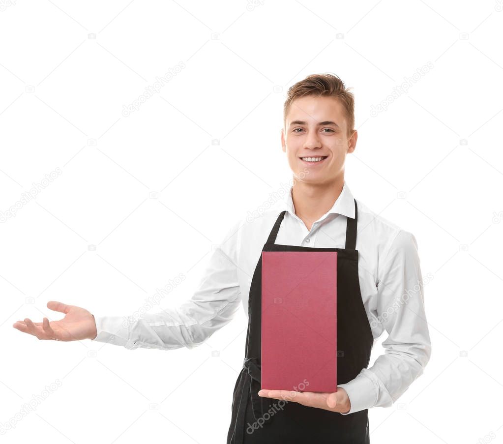 Handsome young waiter with menu on white background