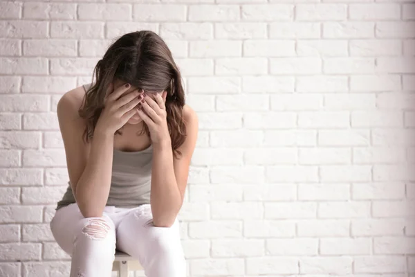 Depressed Young Woman Sitting Brick Wall — Stock Photo, Image