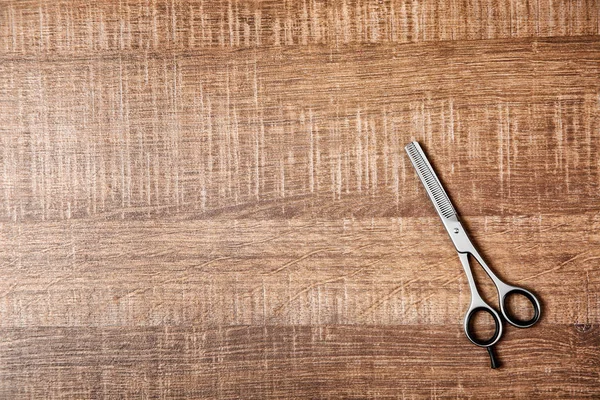 Professional hairdresser scissors on wooden table — Stock Photo, Image