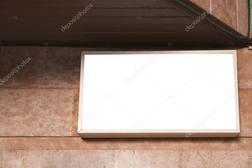 Blank advertising board on wall of building