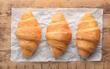 Ahşap masa üzerinde nefis taze kruvasanlar