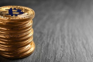Gri zemin üzerine altın bitcoins yığını