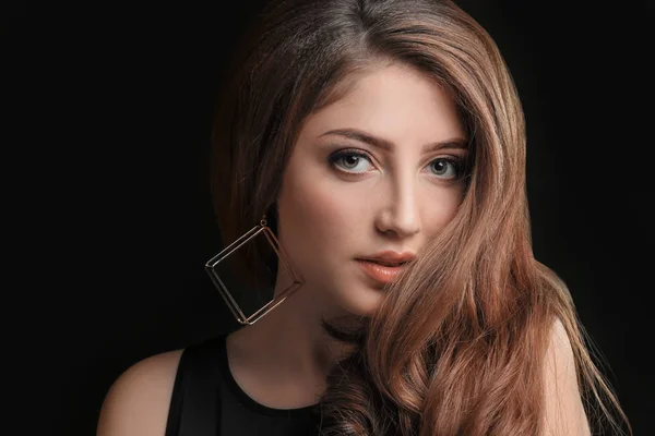 Young woman with caramel hair color on black background — Stock Photo, Image