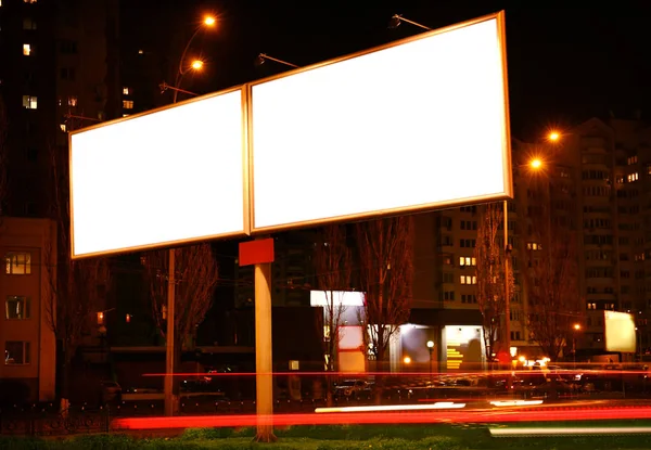 Blank advertising boards on city street at night — Stock Photo, Image