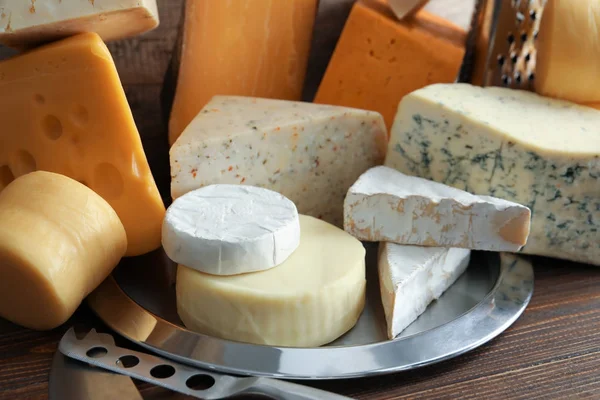 Plate with different kinds of delicious cheese on table, closeup — Stock Photo, Image