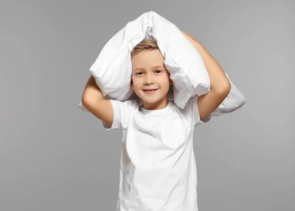 Lindo chico con almohada grande sobre fondo gris — Foto de Stock