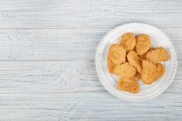 Plate with tasty chicken nuggets on table — Stock Photo, Image