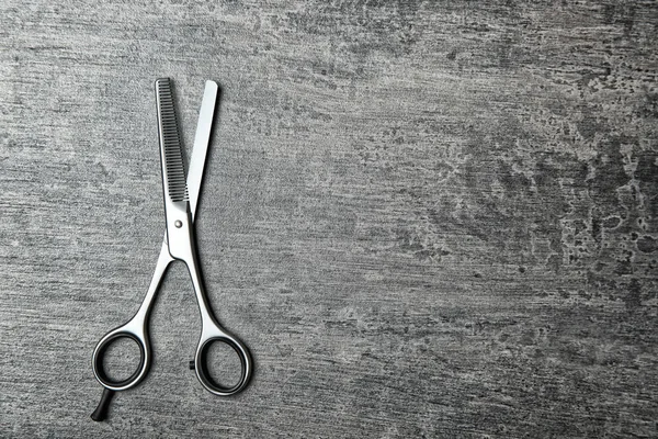 Professional hairdresser scissors on gray table — Stock Photo, Image