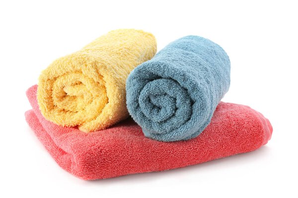 Folded towels on white background