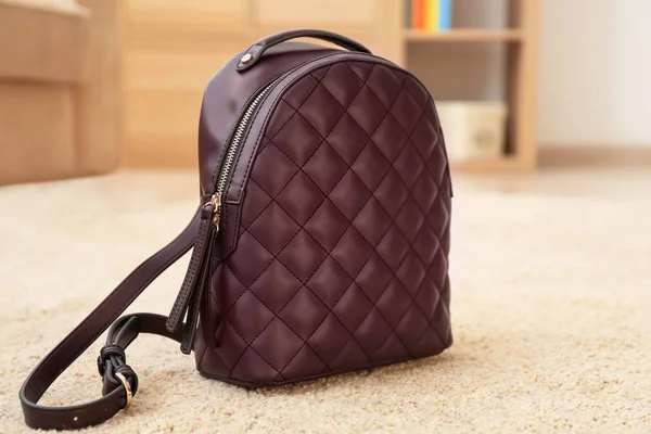 Stylish backpack on floor — Stock Photo, Image