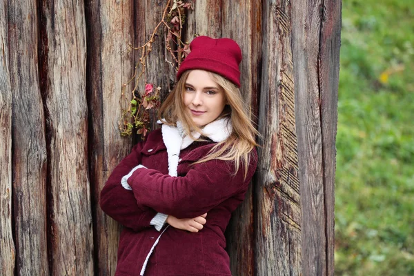 Attractive hipster girl near wooden fence outdoors — Stock Photo, Image