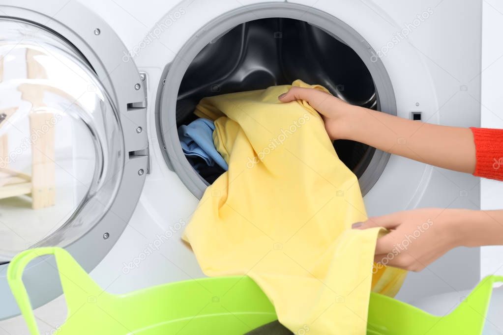 Young woman doing laundry, closeup
