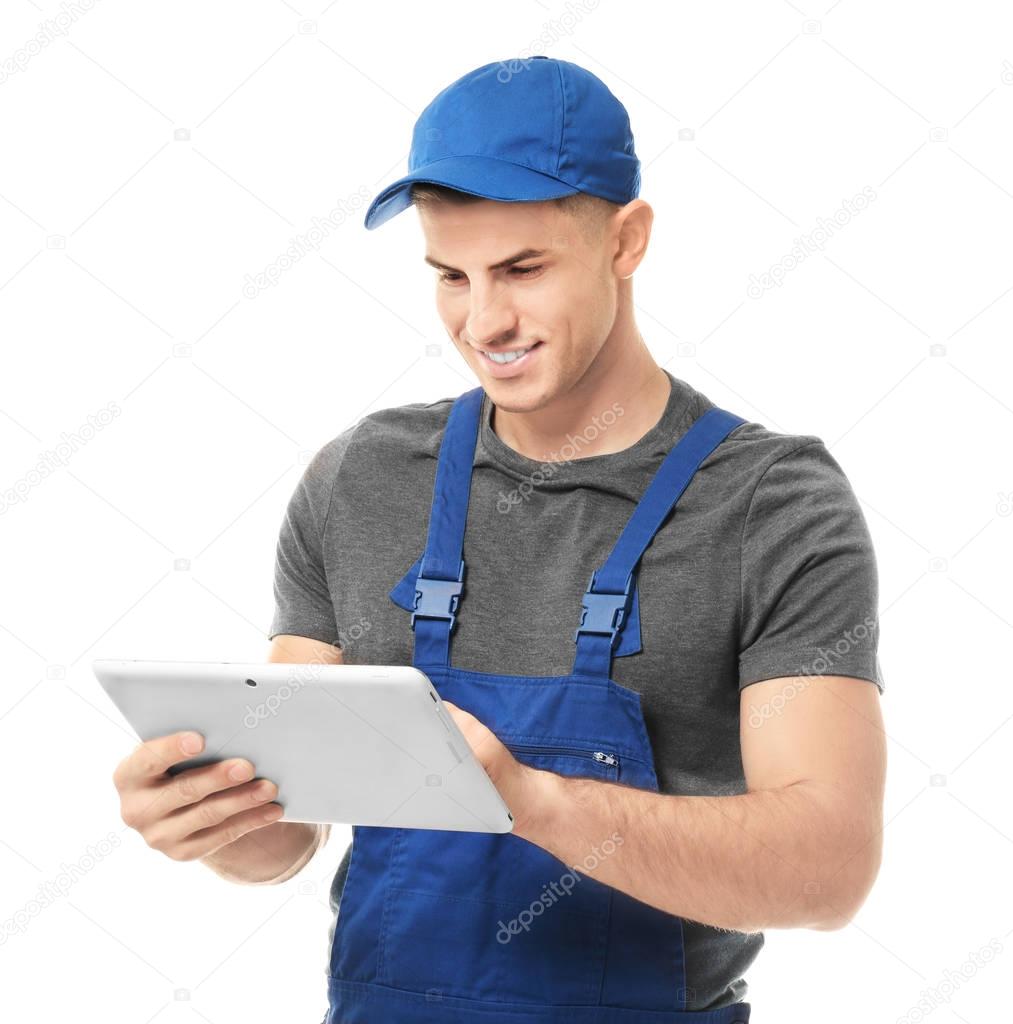 Handsome auto mechanic with tablet computer on white background
