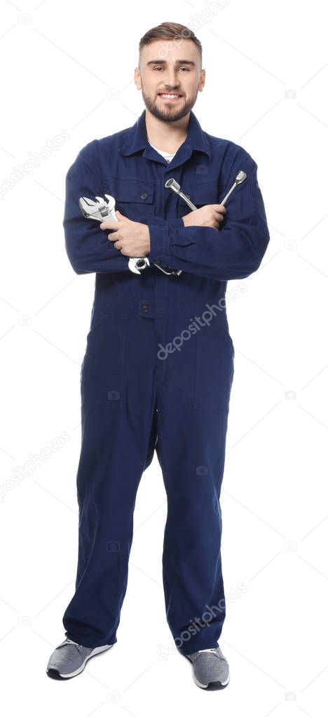 Handsome auto mechanic with tools on white background