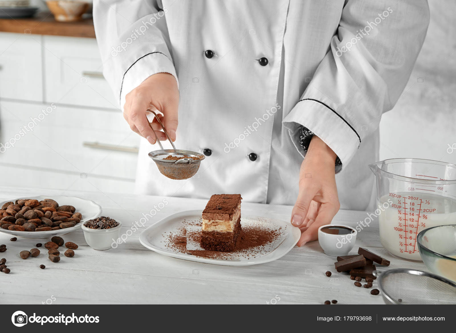 Female Chef Decorating Tasty Chocolate Cake In Kitchen Stock