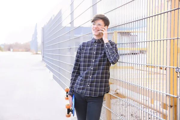 Hipster Teenager Talking Phone Fence Outdoors — Stock Photo, Image