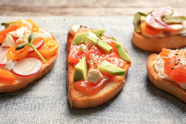 Tasty fresh bruschettas on board — Stock Photo, Image