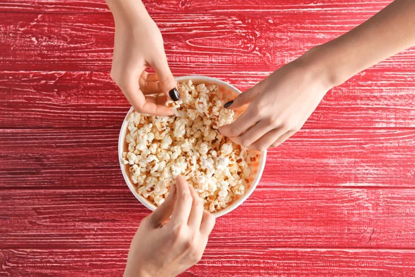 Women Eating Tasty Popcorn Table Top View — Stock Photo, Image