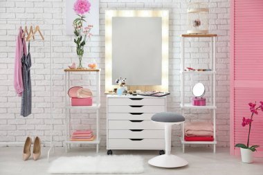 View of makeup room with decorative cosmetics and tools on dressing table clipart