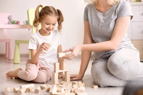Madre y linda niña jugando con bloques de construcción en casa —  Fotos de Stock