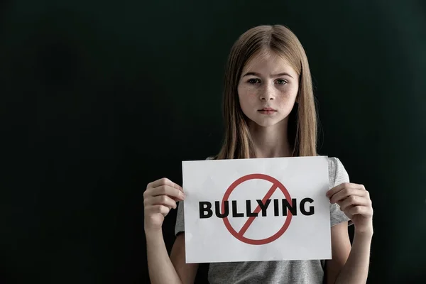 Sad Teenage Girl Holding Sign Crossed Word Bullying Color Background — Stock Photo, Image