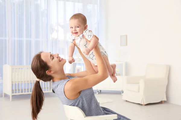 Young mother with cute baby at home — Stock Photo, Image