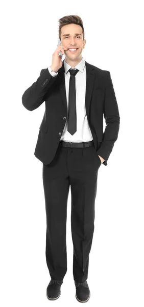 Young man in formal clothes with cell phone on white background — Stock Photo, Image