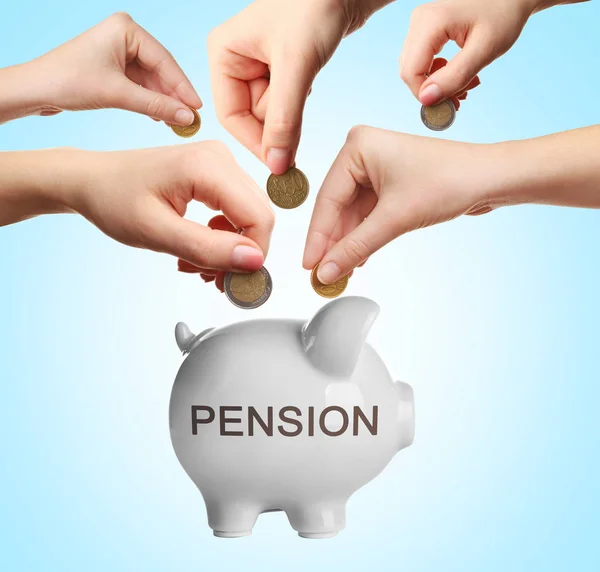 People putting coins into piggy bank for accumulation of pension savings on color background — Stock Photo, Image