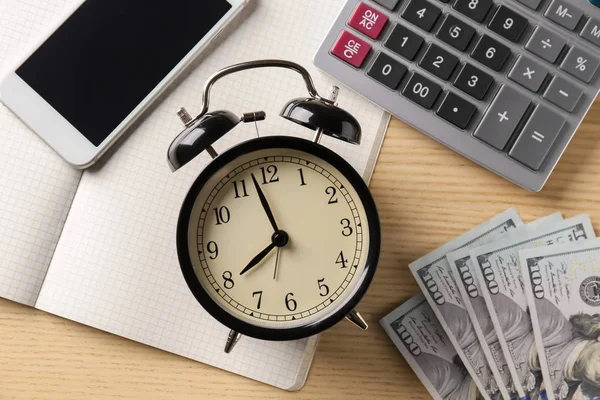 Samenstelling met klok, geld en calculator op houten achtergrond — Stockfoto